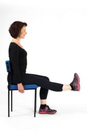 Woman demonstrating thigh strengthener with leg lifted