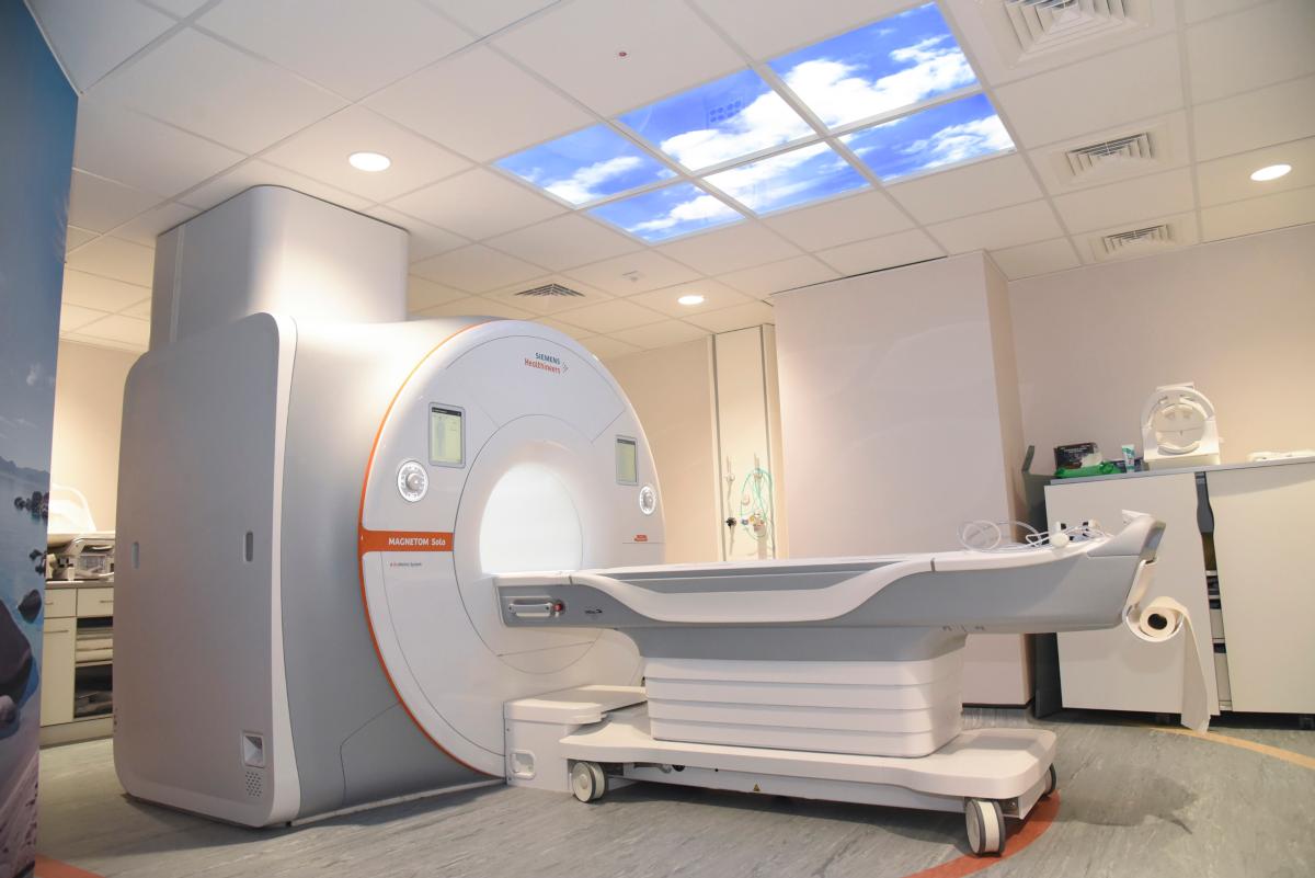 Large white clinical-looking machine, an MRI scanner,