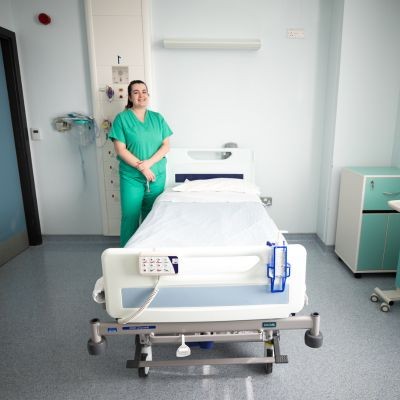 A nurse standing next to a hospital bed