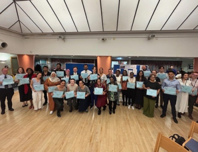Group of people smiling and holding certificates