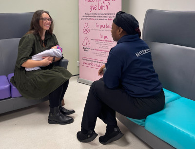 Mother talking with community midwife